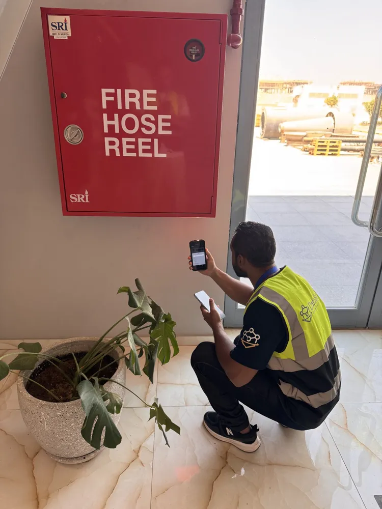 A DataSync operator scanning an asset at the KSB building entrance